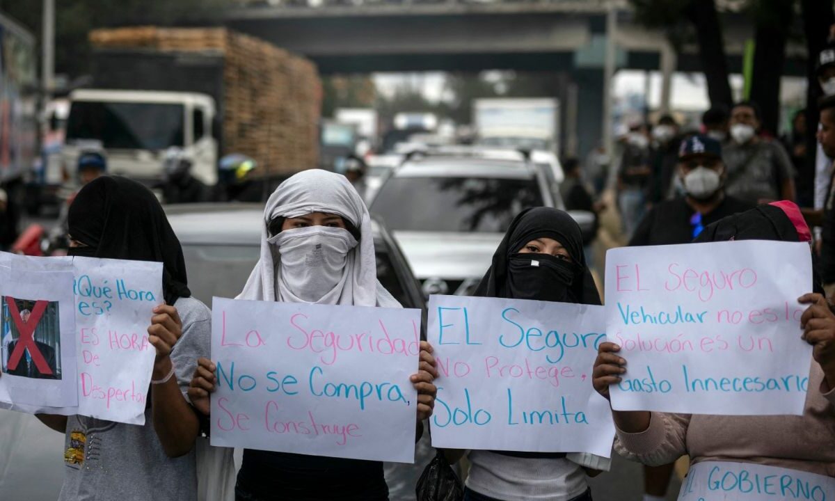 Manifestantes bloquean una calle durante una protesta contra el seguro vehicular obligatorio en la Ciudad de Guatemala