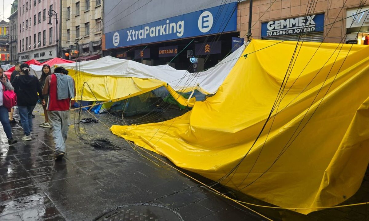 La lluvia y fuertes vientos ocasionaron la caída de un poste de alumbrado público sobre casas de campaña del mega plantón de la CNTE.