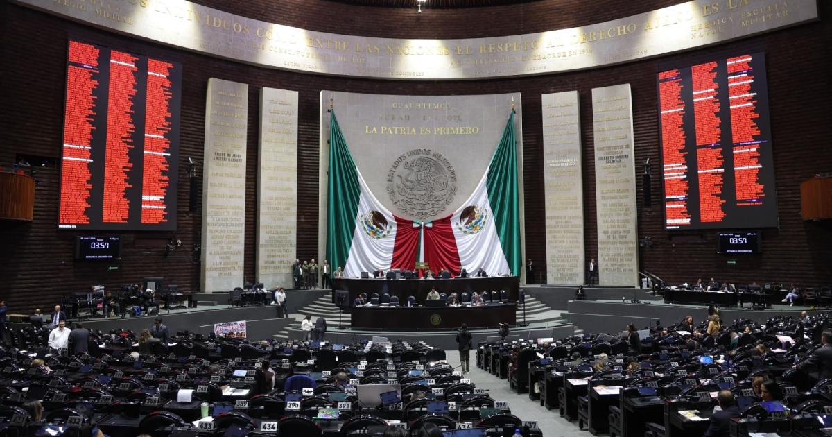 Vista general del pleno de la Cámara de Diputados de México en el Palacio Legislativo de San Lázaro. Al fondo se ubica el presídium y la Mesa Directiva frente al Muro de Honor con la inscripción «LA PATRIA ES PRIMERO», enmarcado por la Bandera Nacional monumental y las placas con letras de oro.